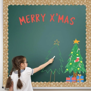 Scalloped gold glitter snowflake border trim being applied to a classroom chalkboard