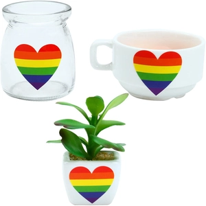 Close-up of rainbow heart prints on a glass jar, ceramic mug, and succulent pot gift set