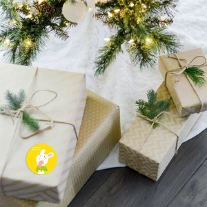 Yellow Happy Easter stickers with white rabbits on festive gift box packaging