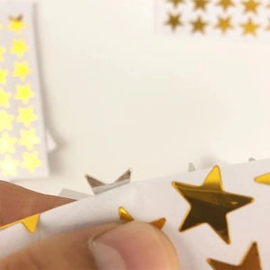 Shiny gold star reward stickers for kids with metallic foil finish on white background