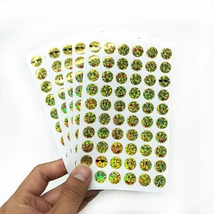 Macro shot of glittery gold foil reward stickers featuring various cartoon emoji faces