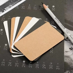 Blank kraft card set in brown, black, and white with rounded corners and a pencil