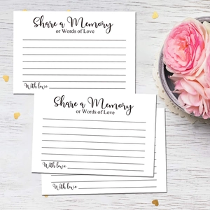 Elegant white Share a Memory cards with gold heart confetti on white wood surface