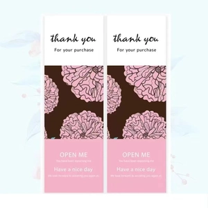 Detail showing rectangular floral stickers for gift box packaging with OPEN ME greeting