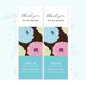 Detailed view of floral OPEN ME rectangular stickers for gift box and bakery packaging