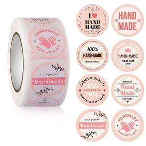 Macro view of assorted pink and black handmade adhesive labels for bakery packaging