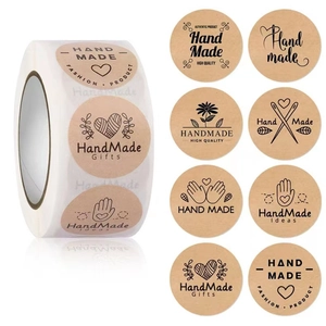 Close-up of eight vintage kraft paper handmade stickers with heart and floral designs