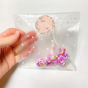 Polka dot frosted gift bag with Happy Mother's Day sticker and Dum Dums lollipops