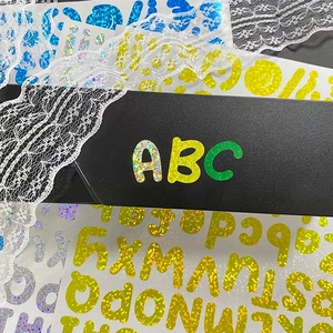 Glitter alphabet stickers in multiple colors for DIY crafts on a black background