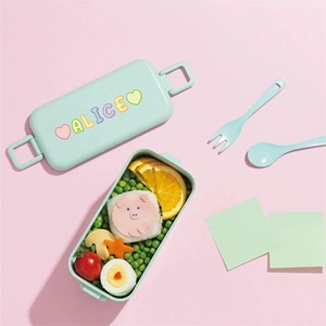 Green portable lunch box with colorful Alice name stickers and cutlery set included