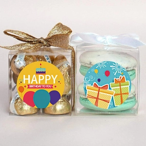 Detail showing 1.5 inch Happy Birthday stickers on clear gift boxes with ribbons