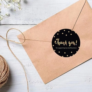 Black and gold Thank You stickers for small business packaging on kraft envelopes