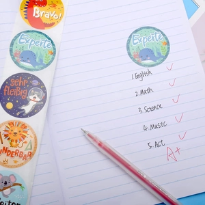 Cartoon dinosaur and animal reward stickers with German motivational text on paper