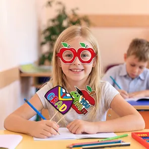 School graduation photo booth props with paper glasses and signs for kids party