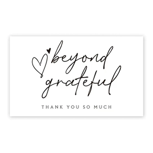 Detail of white thank you card with beyond grateful text and pink heart design