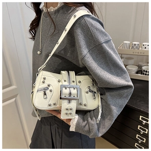 Detailed shot of white Y2K style shoulder bag with silver rivets and large metal buckle