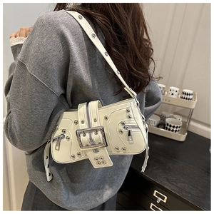 Detailed shot of cream white underarm bag with silver studs and metal buckle detail