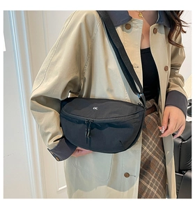 Detail of black nylon half-moon saddle bag with adjustable strap and circular OK patch