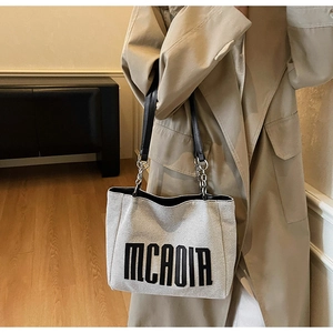 Canvas tote bag with MCAOIA text, leather straps and silver metal chain detail