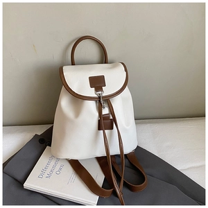 Detail of Korean-style ivory and brown contrast backpack with drawstring and metal lock