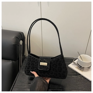 Détail du sac sous le bras léopard noir avec boucle dorée et double bandoulière fine