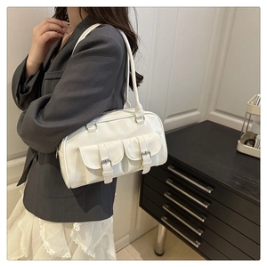 Detailed view of white PU leather bowling bag with vintage buckled pockets and glossy finish
