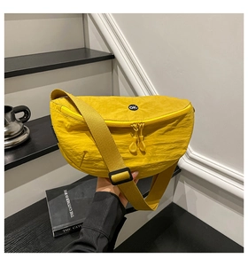 Close-up of vibrant yellow textured nylon saddle bag featuring a round OK embroidery
