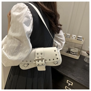 Close-up of white glossy underarm bag with silver square buckle and rivet details