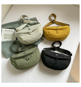 Group shot of colorful nylon crescent crossbody bags in beige, yellow, green and black