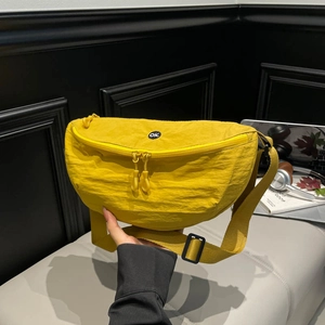 Vibrant yellow nylon crescent crossbody bag with pleated texture and dual zippers