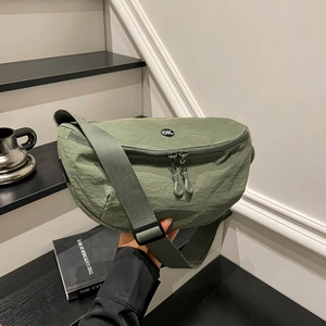 Army green nylon crossbody saddle bag with adjustable strap and circular logo