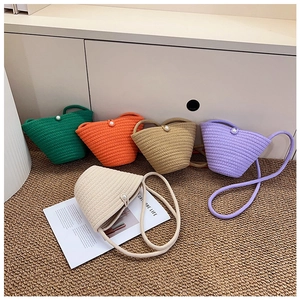 Detail of colorful mini bucket bags with hand-woven yarn texture and pearl closure