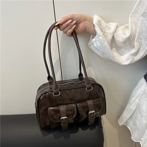 Dark brown patent leather bowling bag with twin front pockets and polished finish