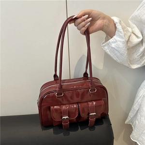 Red glossy patent leather bowling bag with twin front pockets and shoulder strap