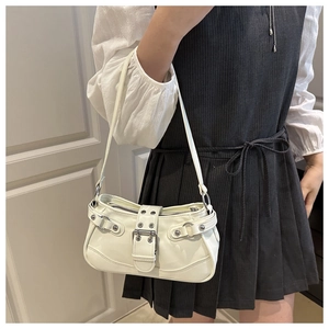 Close-up of white vintage hobo bag with silver rivets and buckles on shoulder