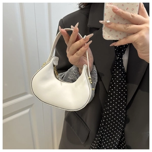 Detail of white mini hobo bag with gold hardware and elegant matte leather finish