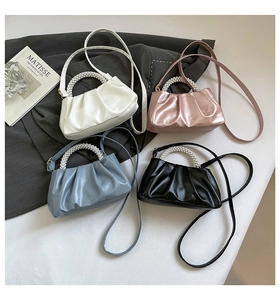Detail view of pearl handle ruched crossbody bags in four elegant colors with a chic design