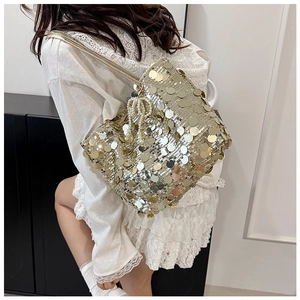 Detail of gold sequin tote bag featuring elegant white pearl bead pendant decoration