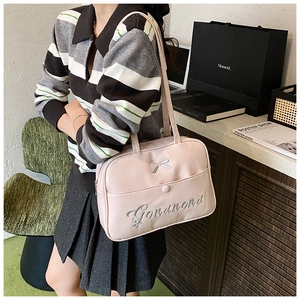 Detail of light pink PU leather backpack with silver bow decoration and embroidery