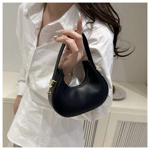 Detailed view of black matte leather mini crescent bag with elegant gold hardware