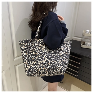 Detail of leopard print tote bag showing the spacious side pocket and canvas texture