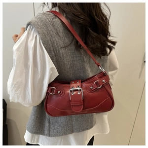 Detail of dark red faux leather baguette bag with silver buckles and Y2K rivets