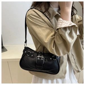 Close-up of black PU leather underarm bag featuring silver metal buckles and punk rivets