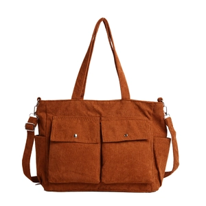 Caramel corduroy tote bag with dual front pockets and adjustable shoulder strap