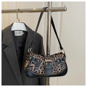 Detail of leopard print shoulder bag with silver metallic buckle and decorative studs
