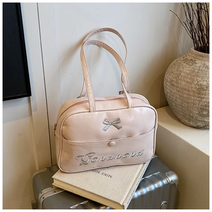 Pink bow backpack on a silver suitcase in a stylish lifestyle travel setting