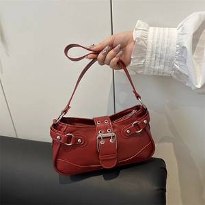 Y2K style red shoulder bag with silver buckles and decorative eyelets hand-held view