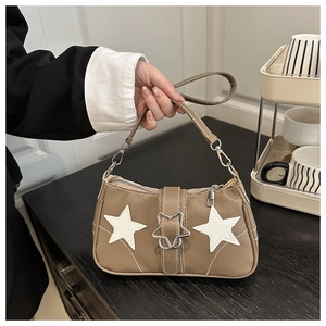 Close-up of khaki denim texture and star metallic buckle on a stylish underarm bag