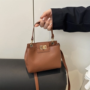 Brown litchi pattern leather evening bag with golden twist lock and shoulder strap