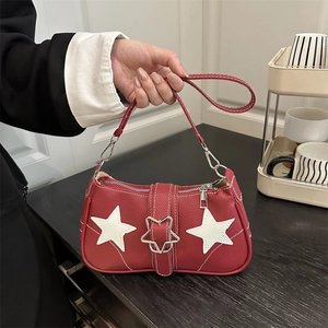 Red pebbled leather shoulder bag with white star patches and metal star buckle